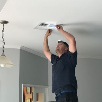 adjusting the duct in the ceiling